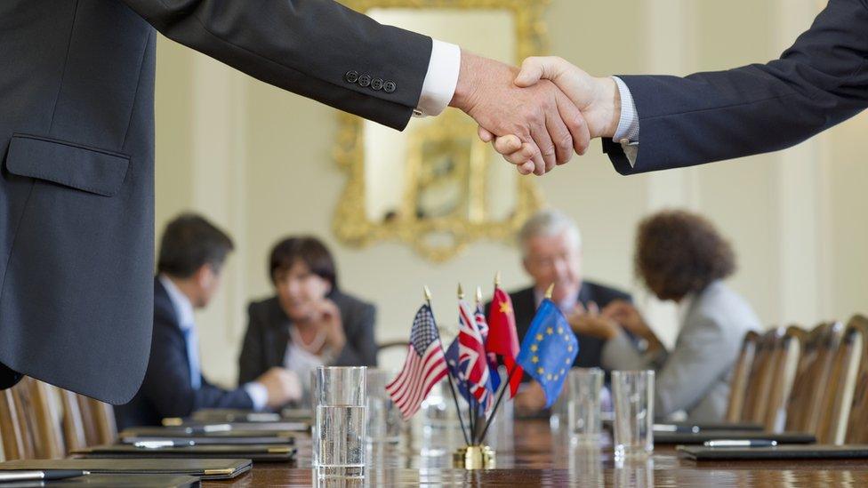 Two men shaking hands at a trade negotiation