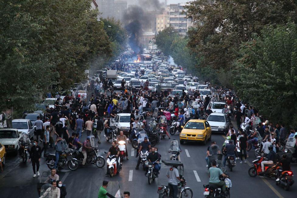 People clash with police during a protest following the death of Mahsa Amini, in Tehran, Iran, 21 September 2022.