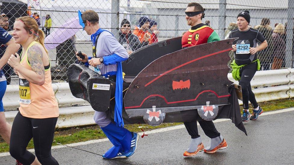 Runners dressed as Batmobile