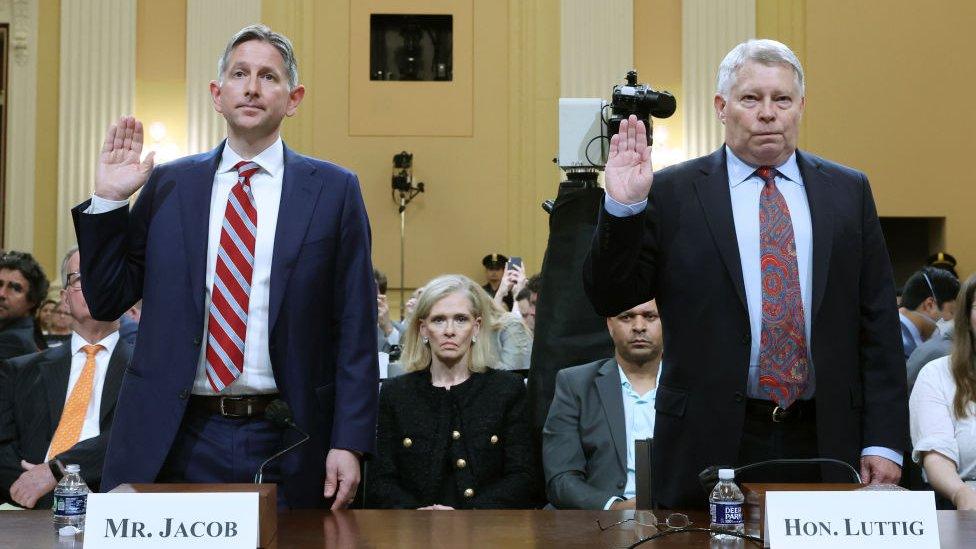 Witnesses holding their hands to be sworn in