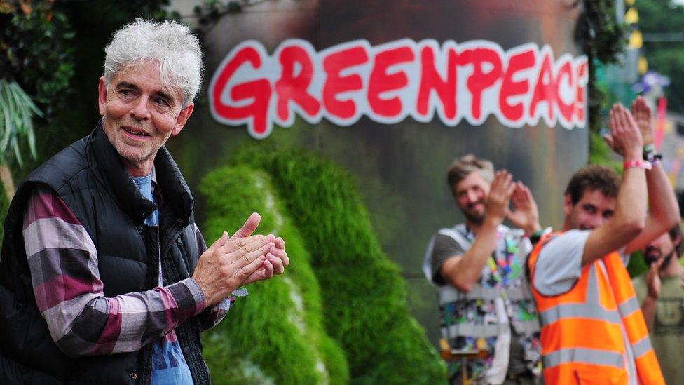 John Sauven, executive director of Greenpeace UK, talks to the Glastonbury Greenpeace crew before the area is opened to the public.