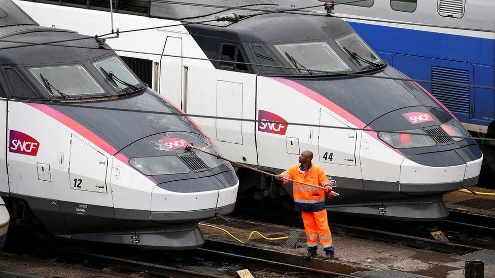 A worker washes a train in Charenton-le-Pont near Paris, France, 31 May