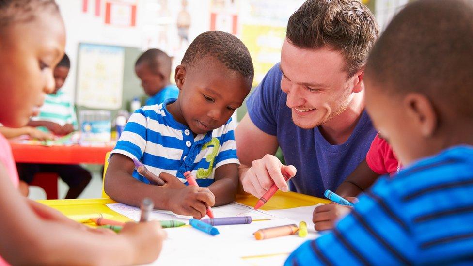 A man with pre-school children