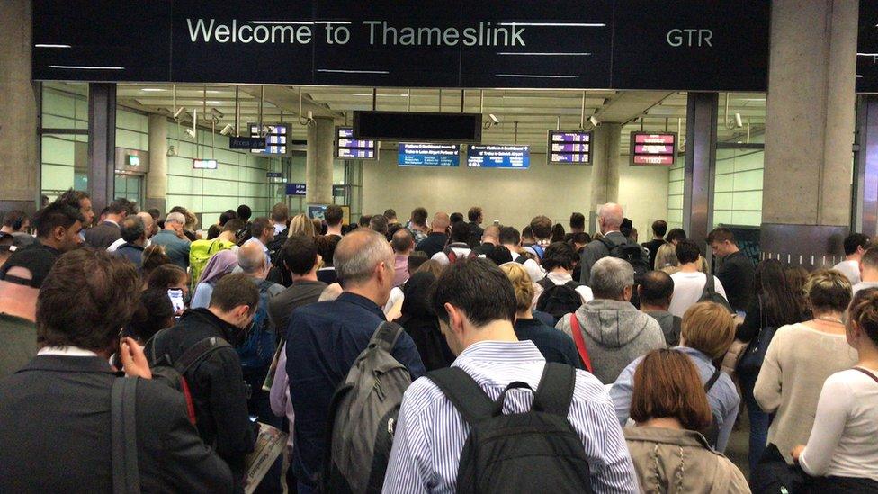 Commuters queuing at a station