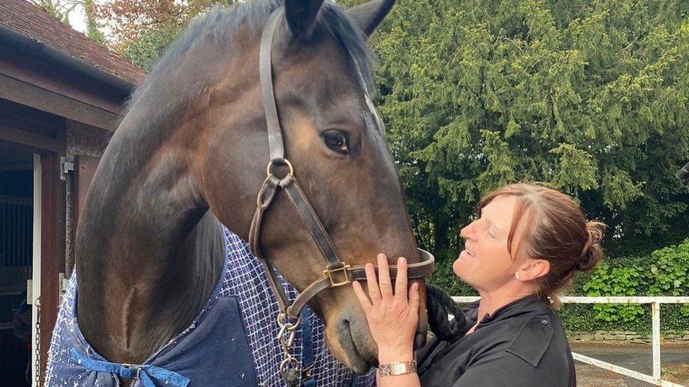 Banks the horse with his handler