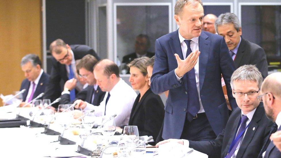 European Council President Donald Tusk (3rd R) gestures as he attends a European Union (EU) heads of state dinner during an EU summit in Brussels on February 19, 2016.