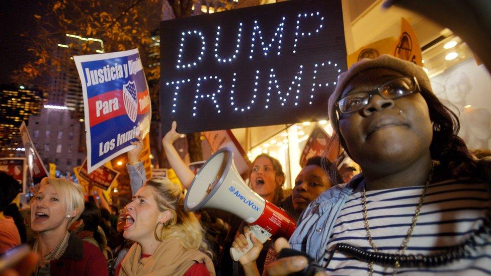 Sasha Murphy, of the ANSWER Coalition, leads demonstrators in a chant during a protest against Republican presidential candidate Donald Trump"s hosting "Saturday Night Live" in New York, Saturday, Nov. 7, 2015.