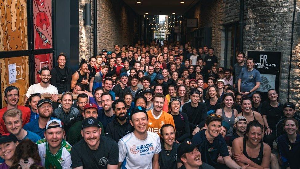 A big group of people posing for a photo outside