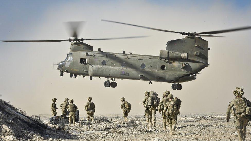 British soldiers and a Chinook helicopter in Afghanistan