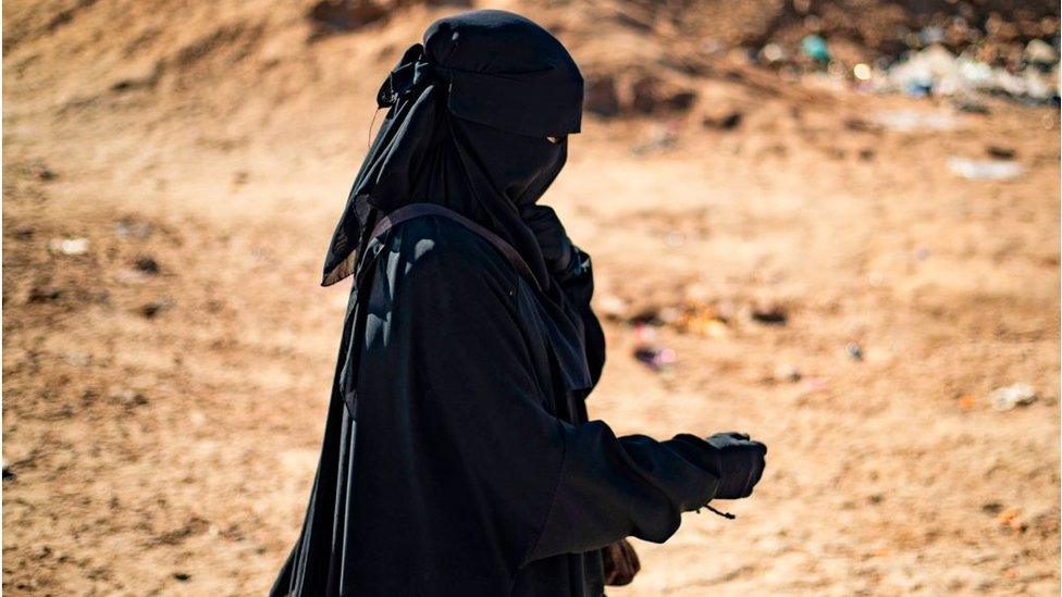 A woman wearing a full face veil