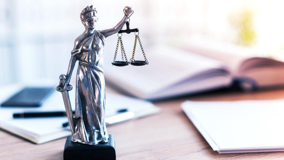 Scales of Justice statue sitting on a desk