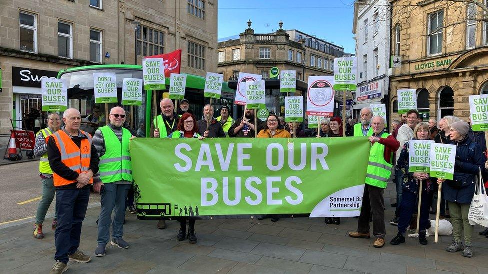 A group of people holding a banner