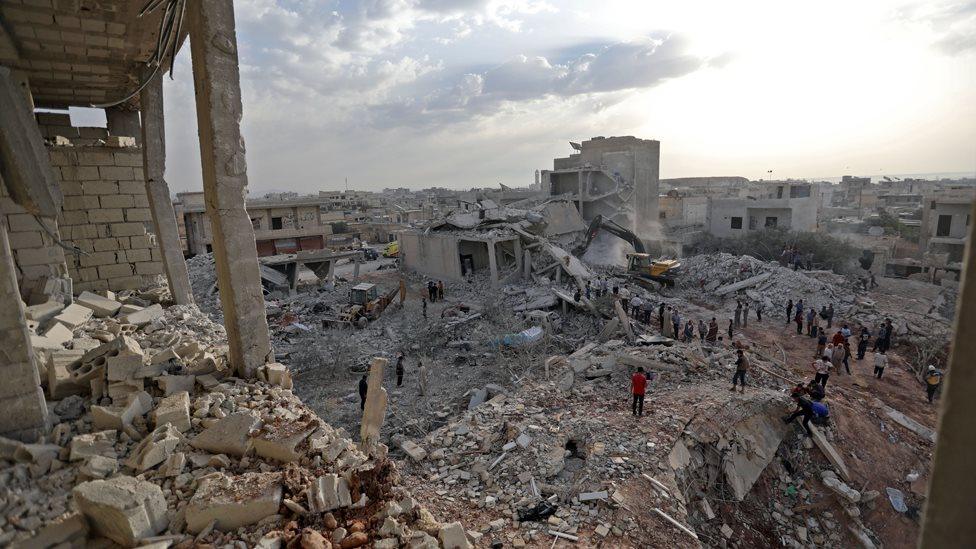 Syrians gather after reported air strikes in opposition-held Zardana, Idlib province, on 8 June 2018