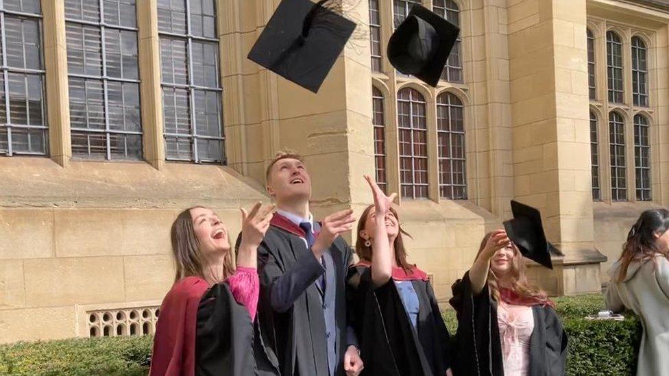 Graduates throwing hats in the air