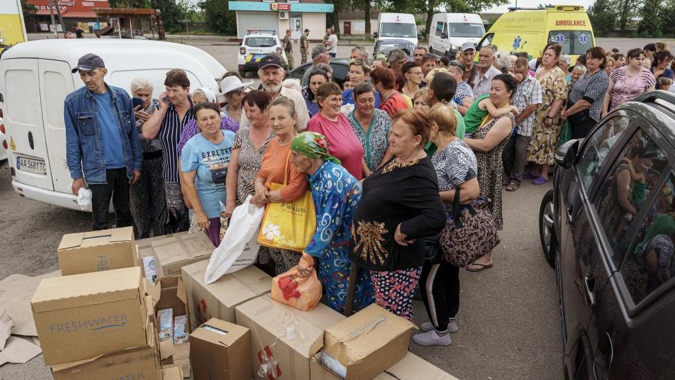 Crowd stood waiting for aid