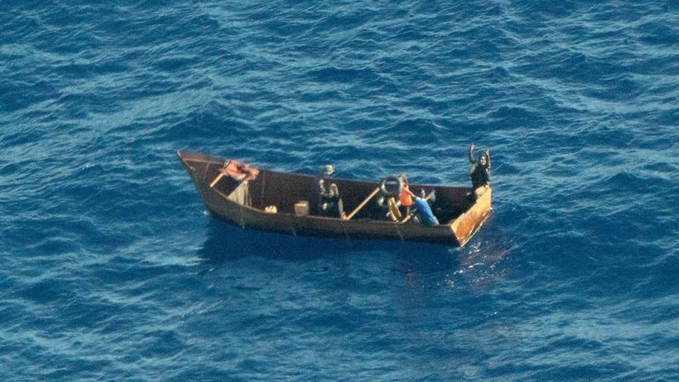 Four survivors in a metal boat