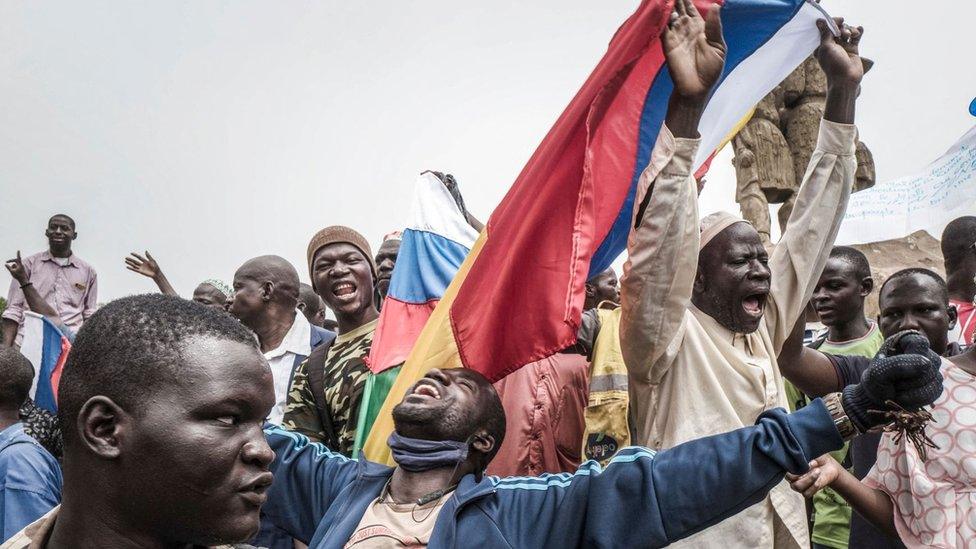 Russians and Malian flags are waved by protesters in Bamako, during a demonstration against French influence in the country on May 27, 2021.