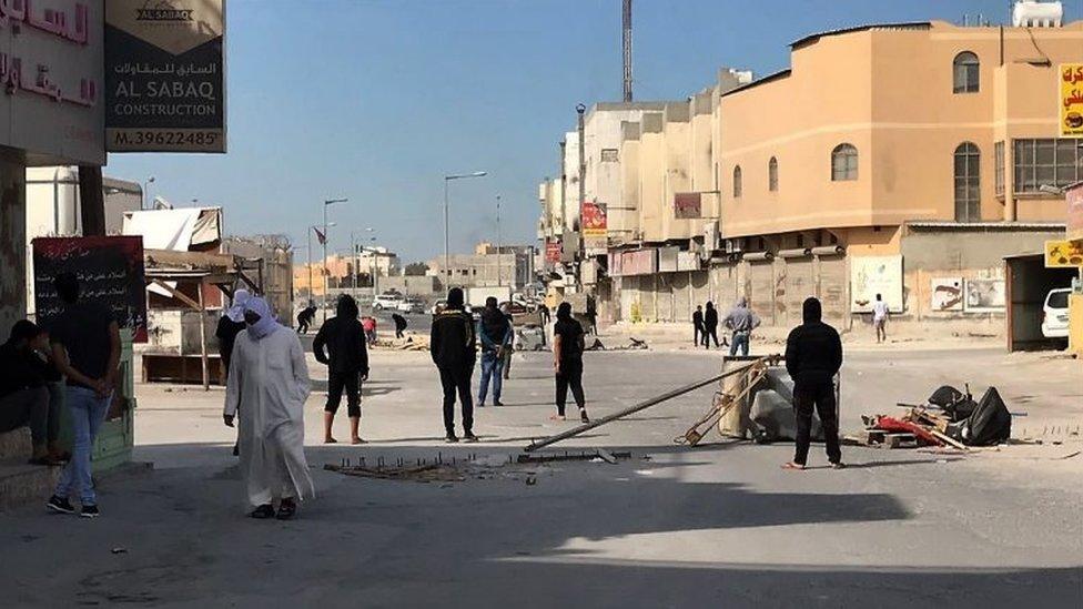 Anti-government protestors block the road in the Jidhafs district of Bahrain, on 15 January 2017