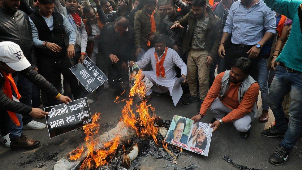 Right wing Hindus burn photos of Mr Azhar and Pakistani Prime Minister Imran Khan