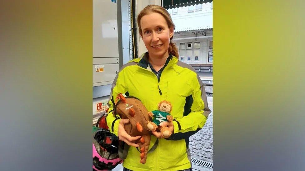 Train staff holding Monkey