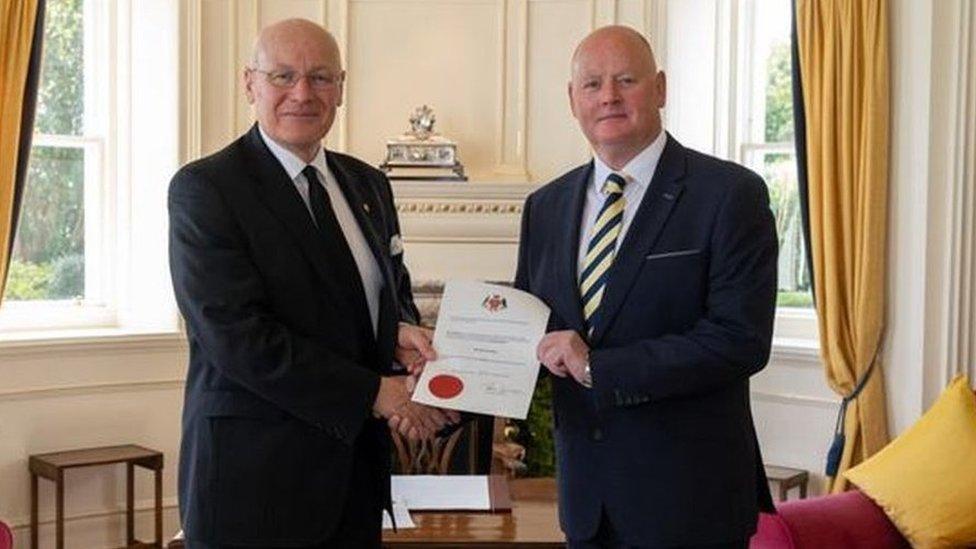 Mr Callister receiving his warrant of appointment from the Lieutenant Governor at Government House