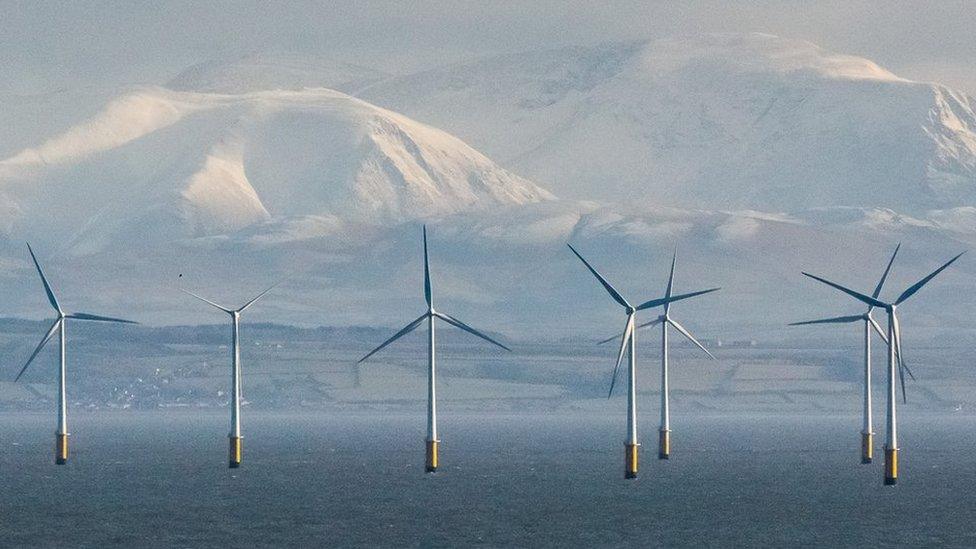 Robin Rigg Wind Farm and the Cumbrian fells from Balcary Point, Dumfries and Galloway, Scotland.