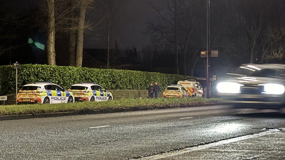 Police vehicles near scene