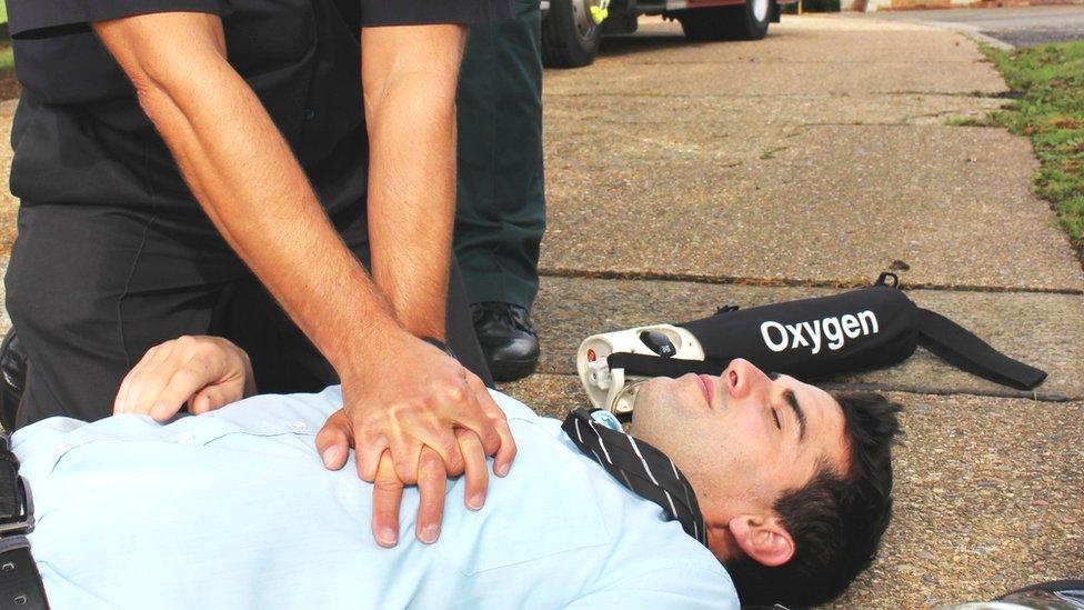 Firefighter treating a patient, posed by a model