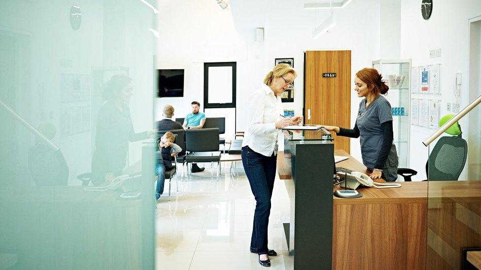 woman waits at reception