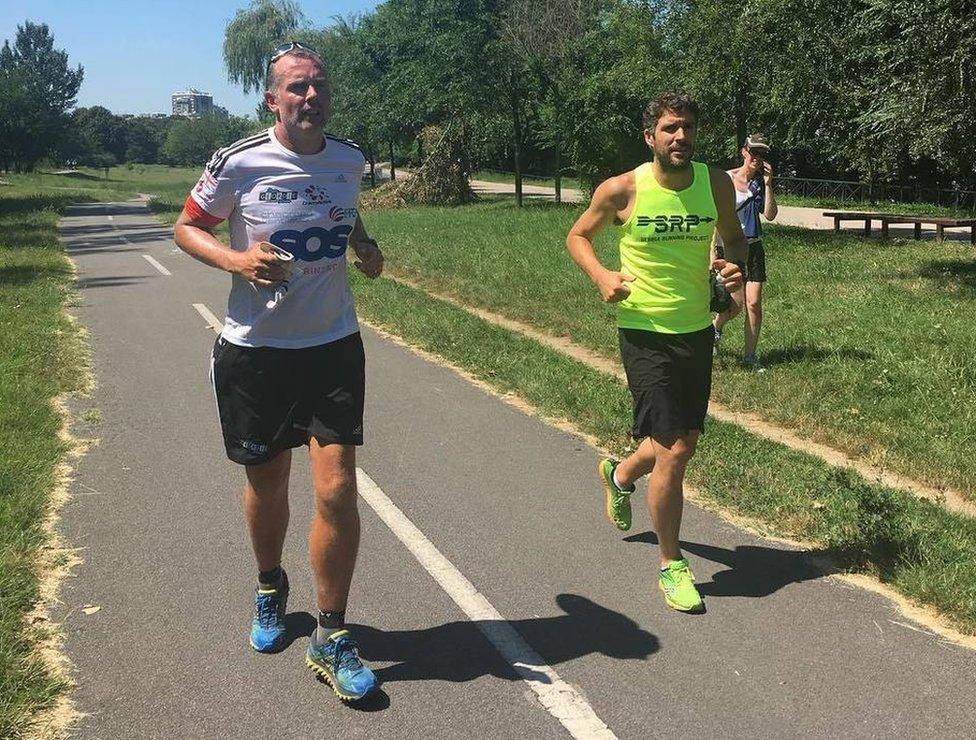 Mark Allison (left) running with Jeremy Lang from the British Embassy in Serbia