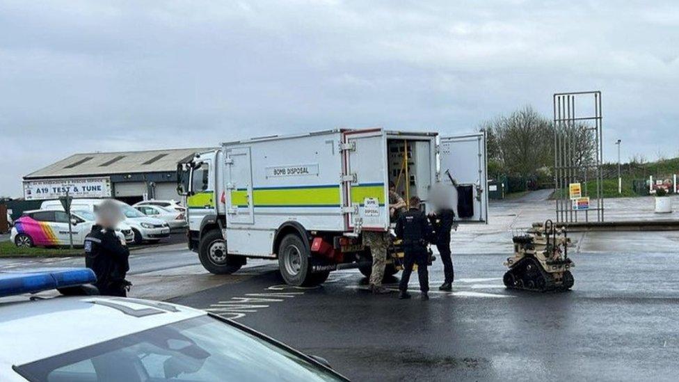 Police and bomb disposal experts at the garage on the A19