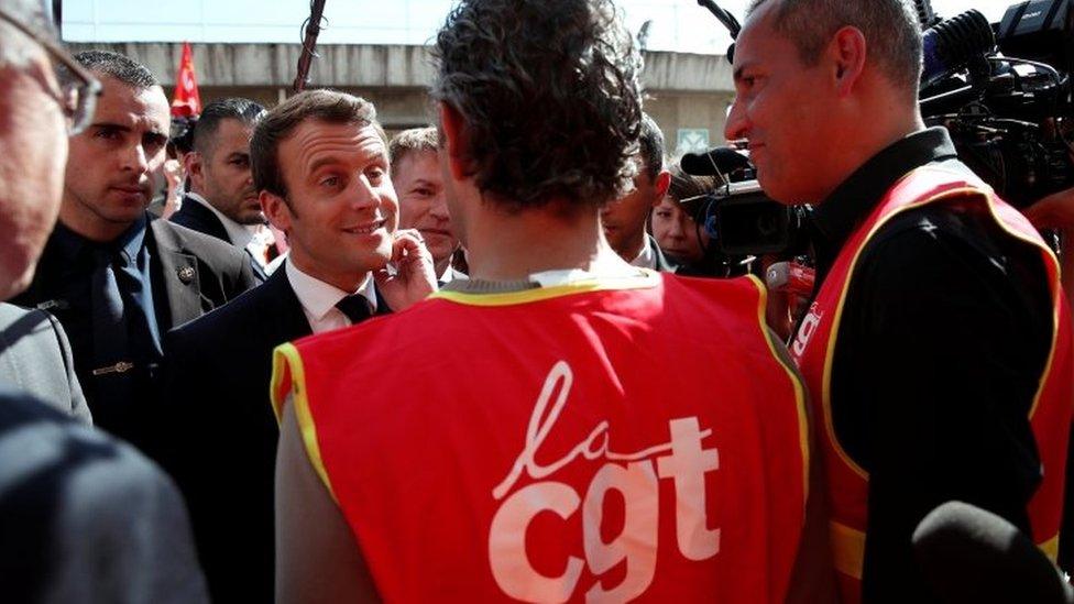 Emmanuel Macron (centre) speaking to labour union activists. Photo: 4 May 2017