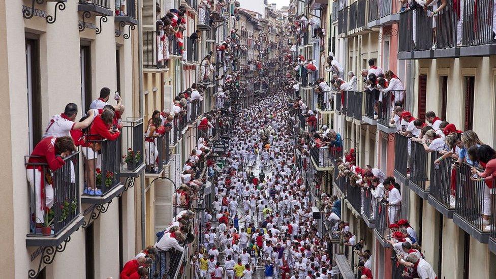 People watch the Running of the Bull in Pamplona.