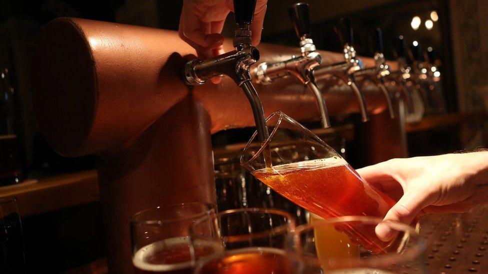 Beer being poured from a tap in a bar