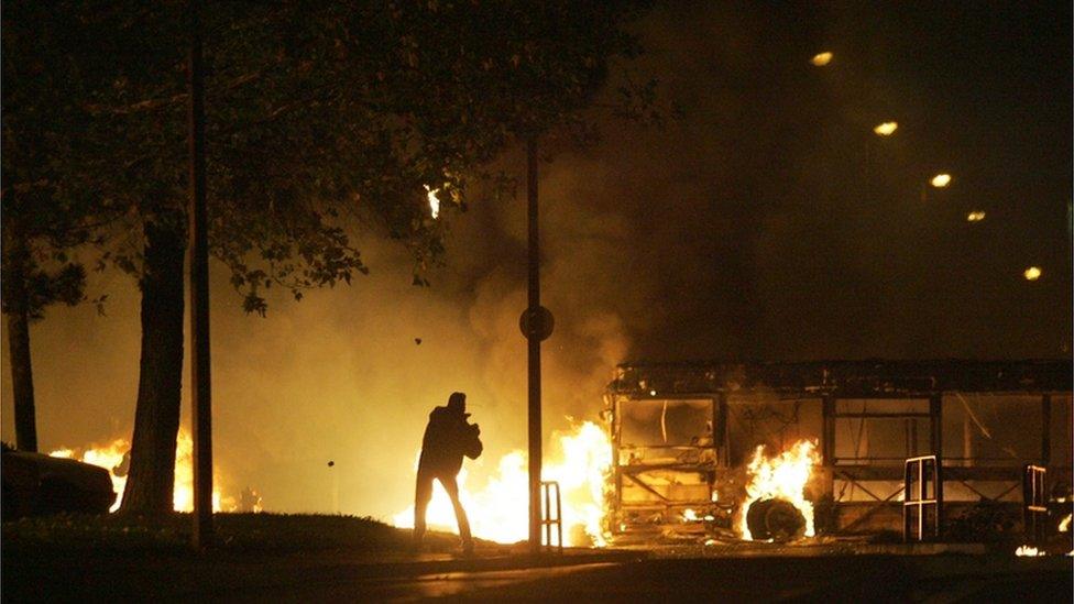 A man throws a molotov cocktail, home-made bomb, petrol bomb, at police in Le Mirail, Toulouse, France, as rioting spreads from the suburbs of Paris, Nov 2005