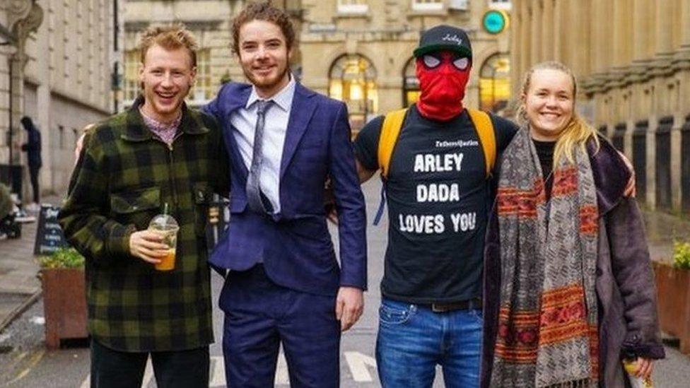 Milo Ponsford, left, Sage Willoughby, second left, Jake Skuse , second right in mask, and Rhian Graham right, accused of criminal damage over the toppling of the statue of slave trader Edward Colston, outside Bristol Crown Court