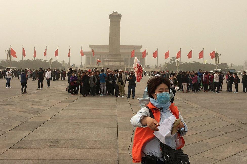 People visit Tiananmen Square as a sandstorm hits Beijing, China 4 May 2017.