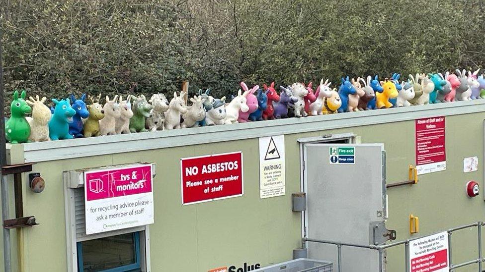 Inflatable toys on a building at a recycling centre