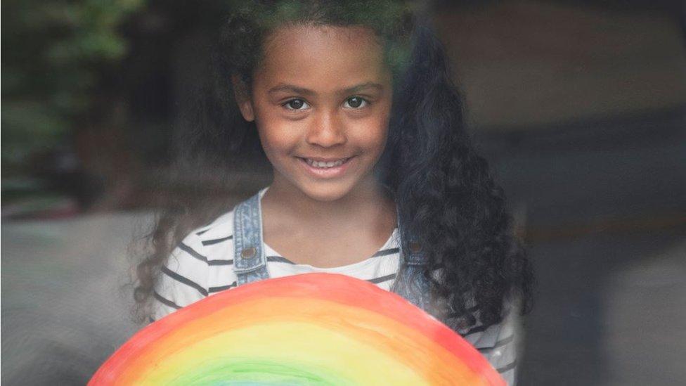 Lotie Ellis Lye-Scott, 4, loves being photographed behind her rainbow. There’s no escaping lessons for her because her mother is a teacher.