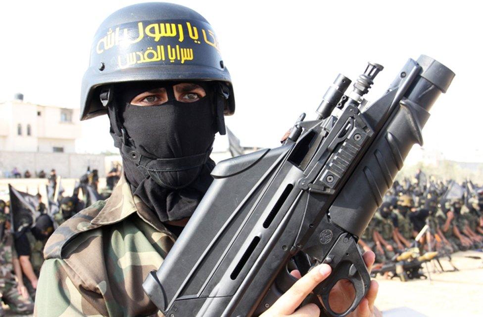 Man holding gun in Gaza parade, 2012