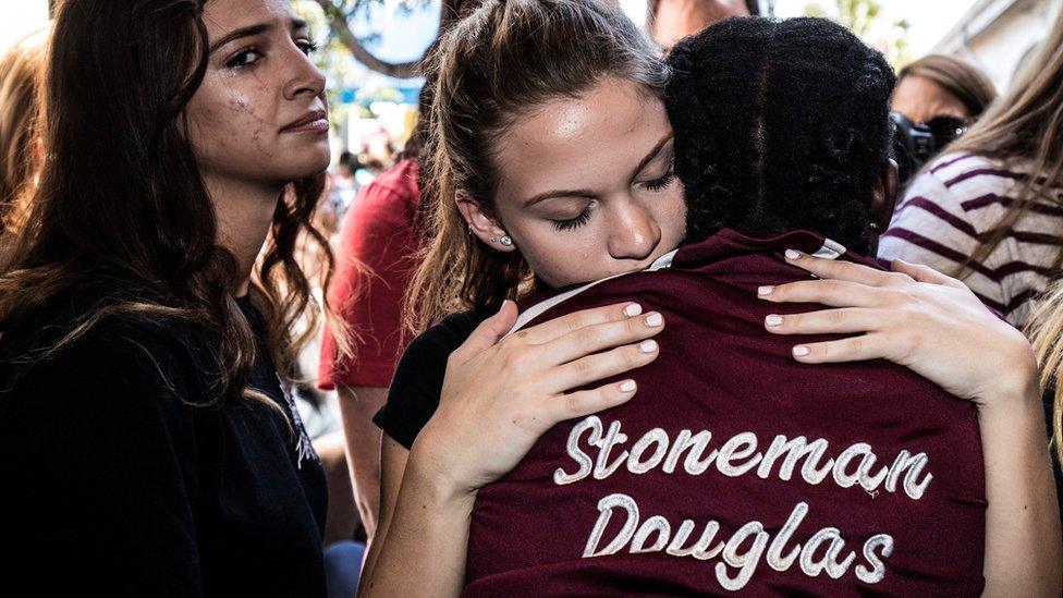 Students from Marjory Stoneman Douglas High School in Parkland, Florida, attend a memorial following a deadly shooting incident, 16 February 2018