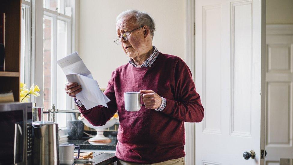 old man reading letter