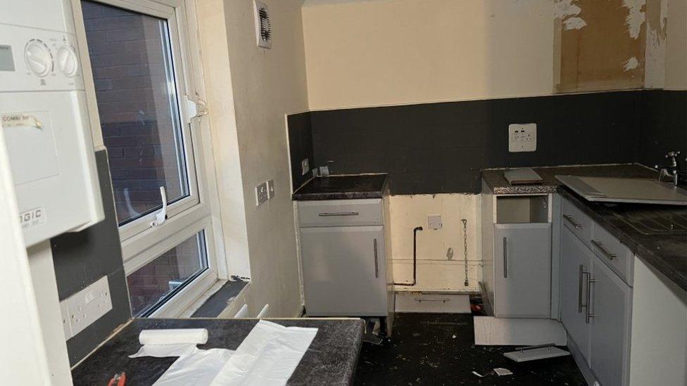 View of the kitchen with white good and flooring removed