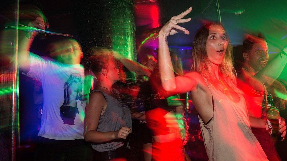 A photo of people dancing in a club.