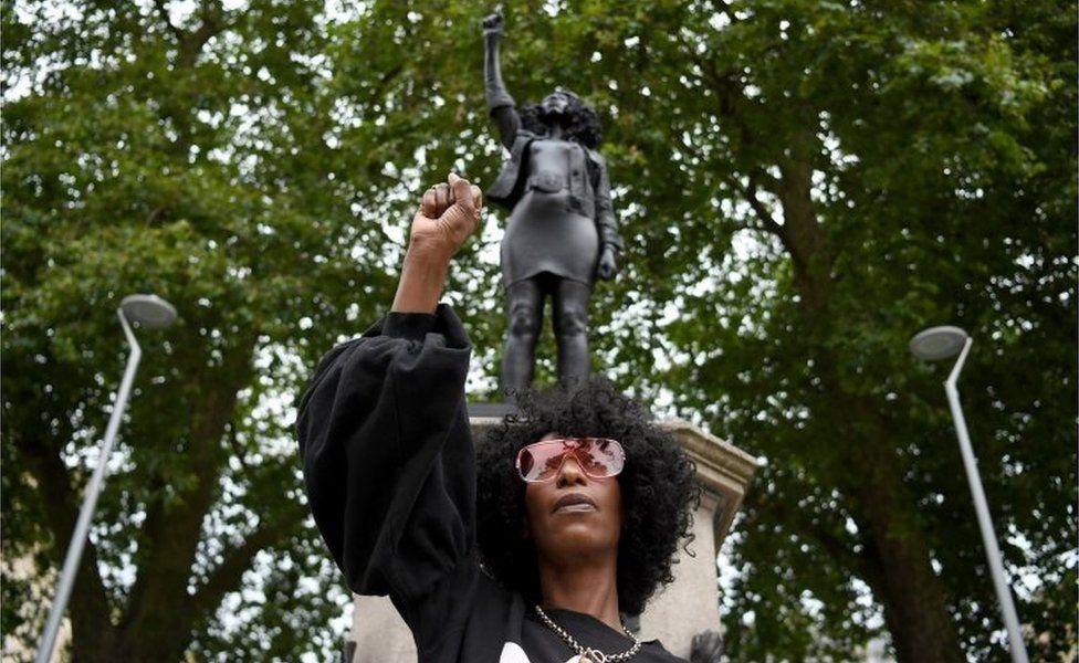 Jen Reid pictured with her statue