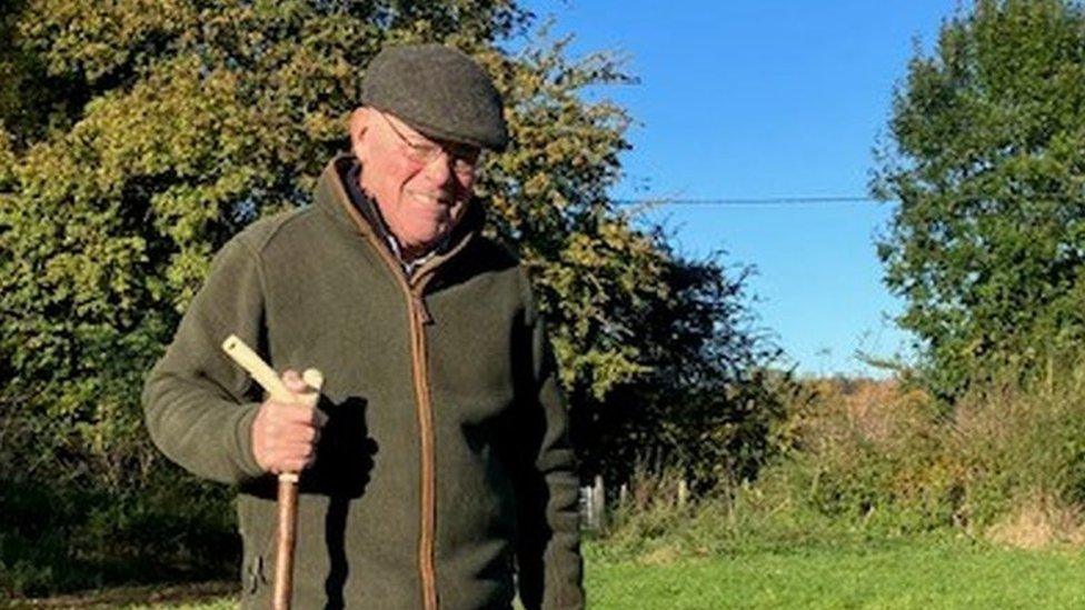 Mr Brown out on a walk in a field