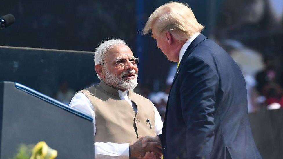 Donald Trump and Narendra Modi shaking hands at the Motera stadium in Gujarat