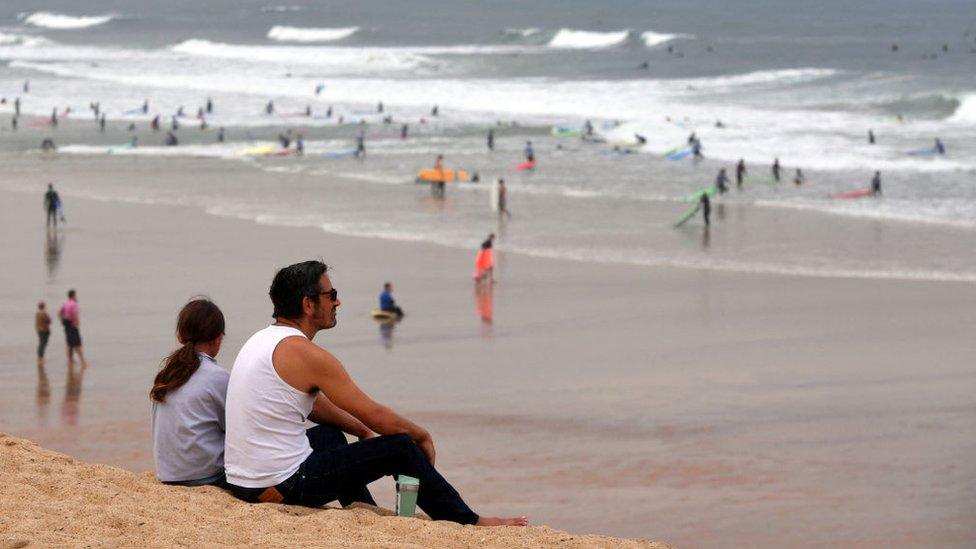 People on a beach in Capbreton, south-western France, 27 October