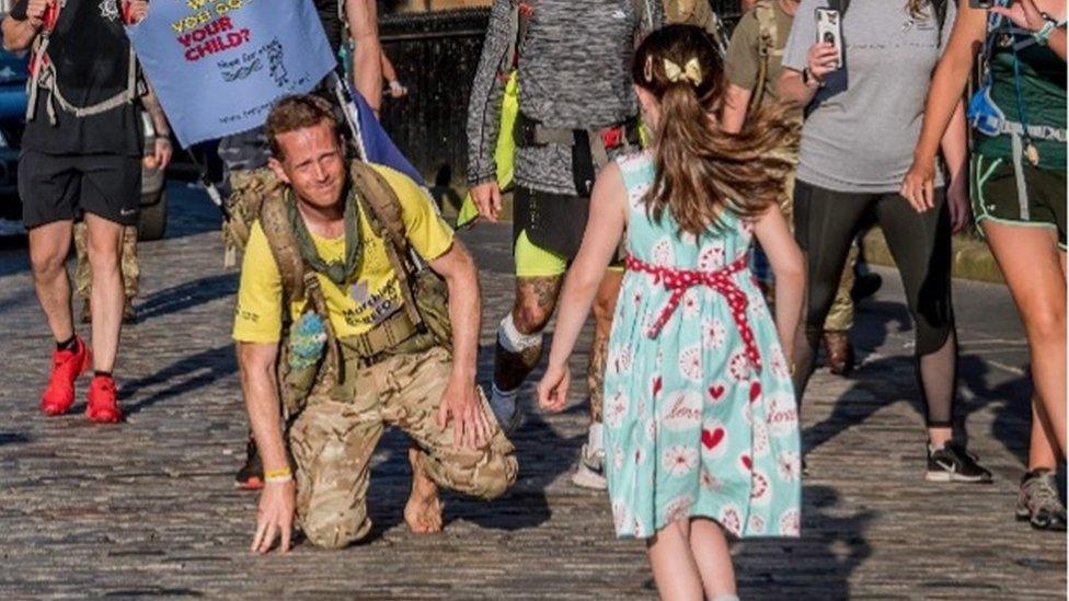 Hasti pictured greeting her Dad after his 700 mile barefoot challenge last year