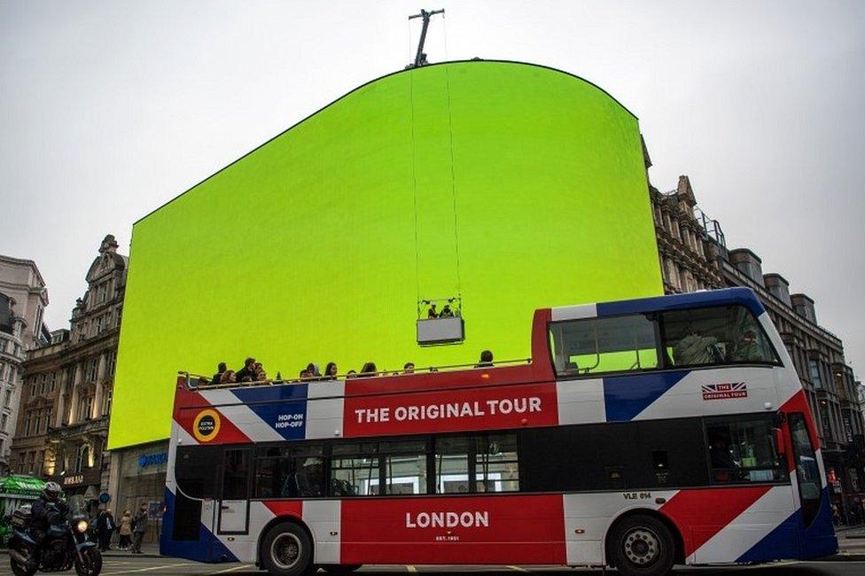 Bus passes Piccadilly screen